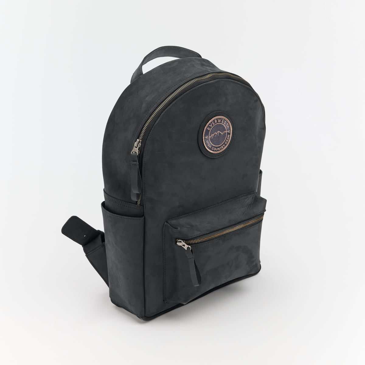 Black leather backpack with the Everwest brand logo patch on a light gray background