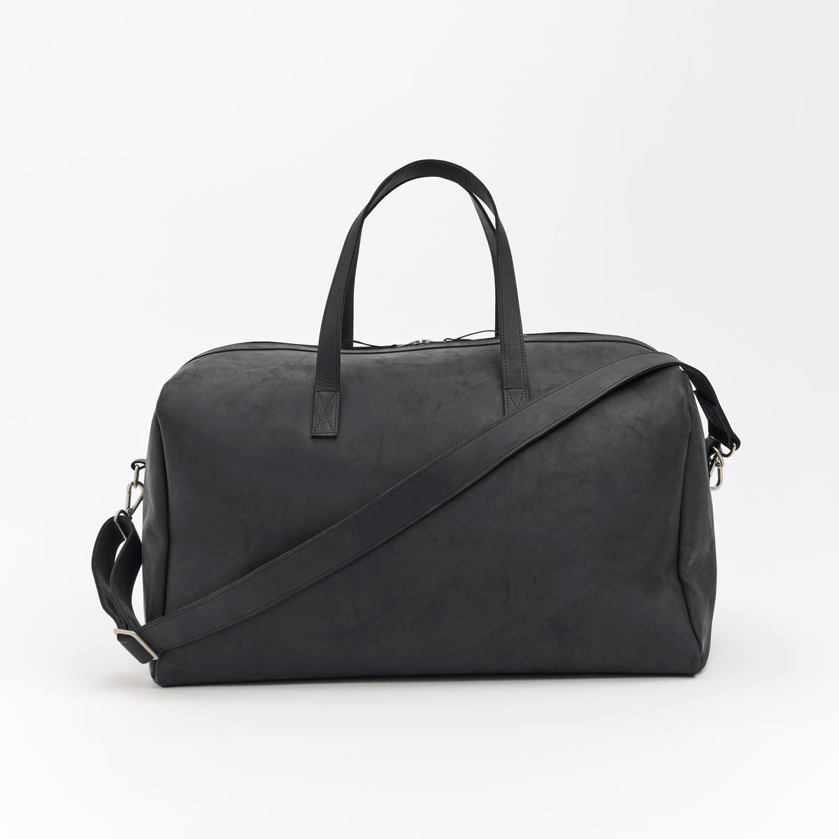 Large black leather duffel bag with a shoulder strap on a white background
