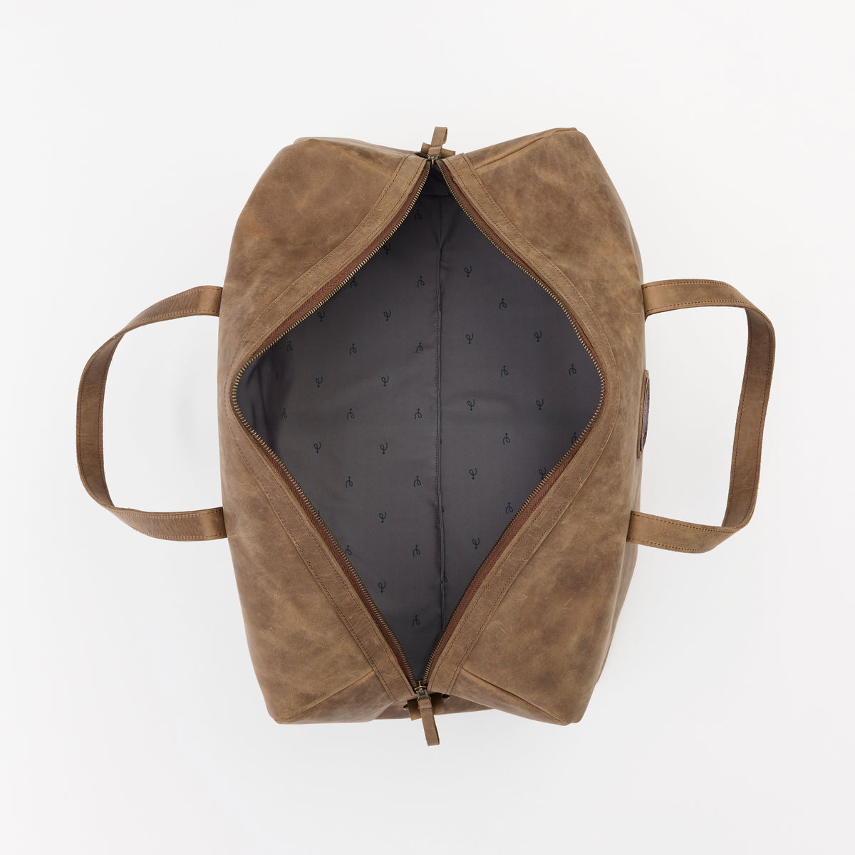 Large brown leather duffel bag with open zippered compartment on a white background