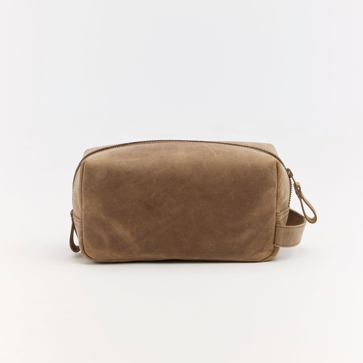 Brown leather toiletry bag on a white background