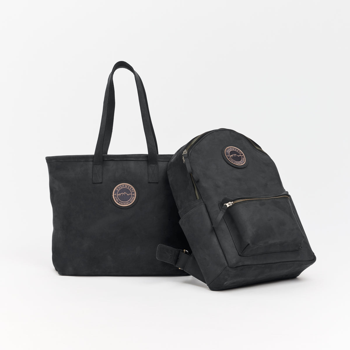Black leather tote bag and black leather backpack with the Everwest brand patch on a white background