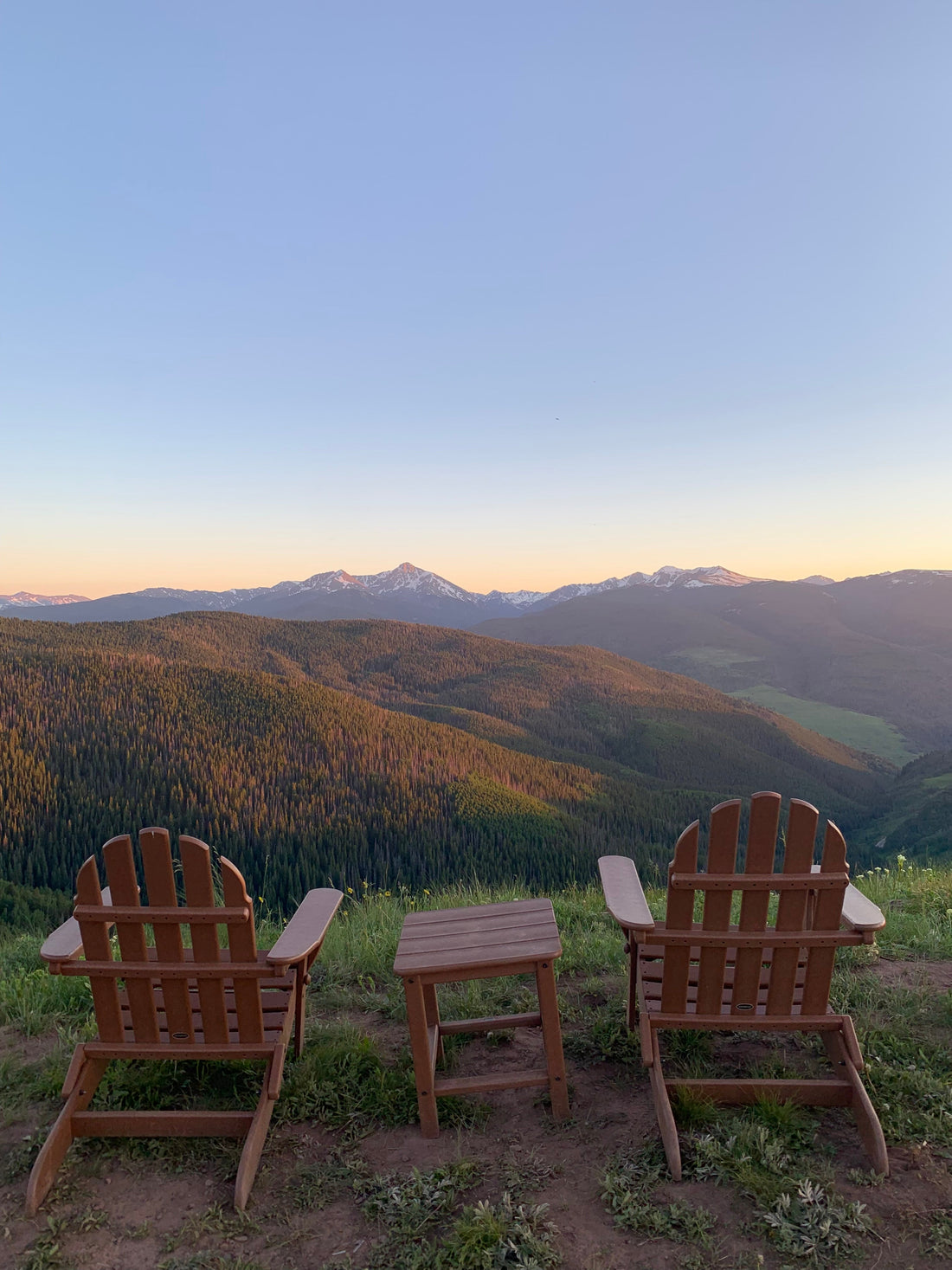 Two chairs looking out over a mountain range 