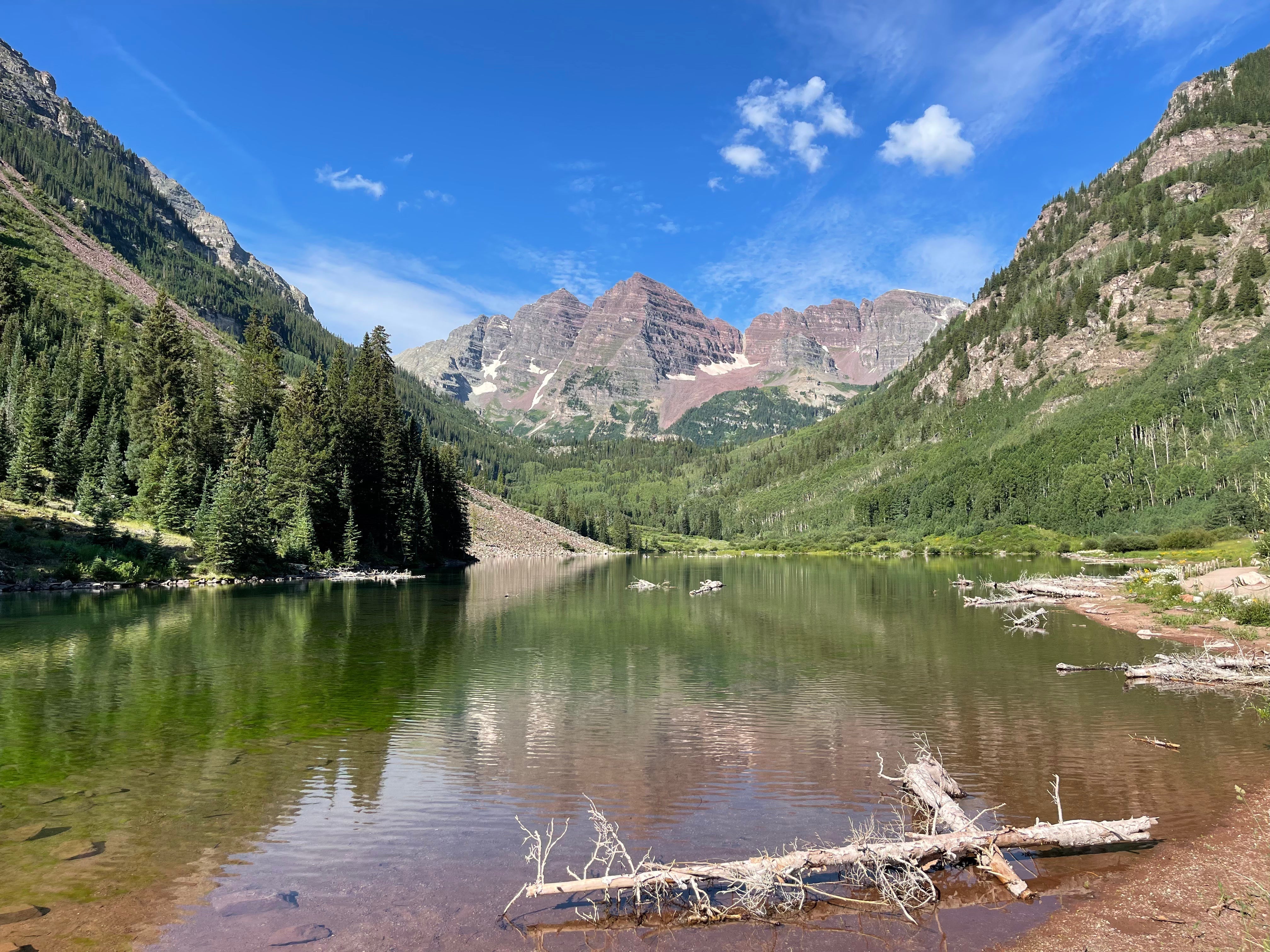 Crystal clear lake in front of towering mountains