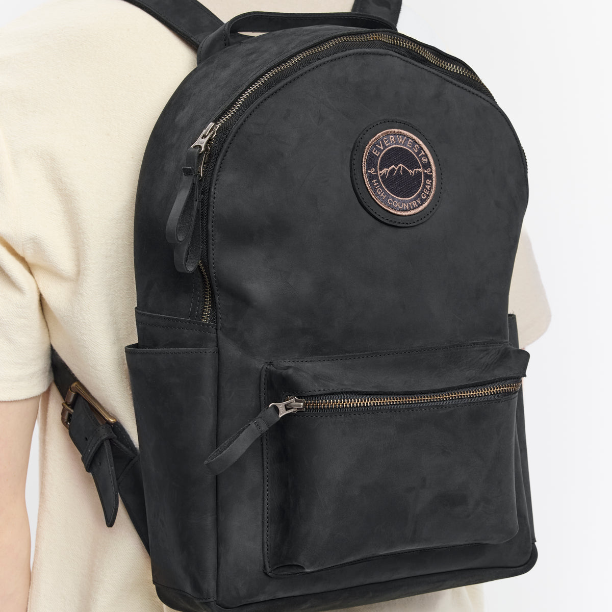 Black leather backpack with the Everwest logo patch on a white background