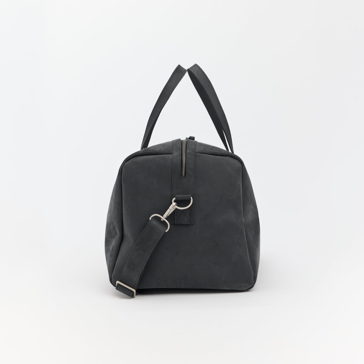 Large black leather duffel bag on a white background