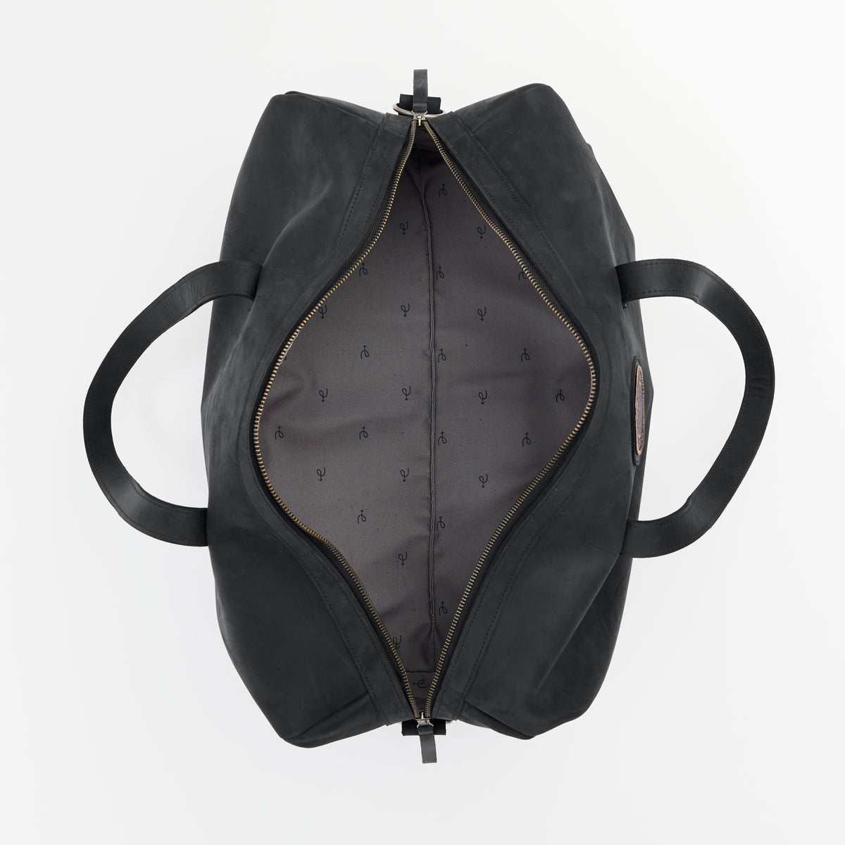 Black leather duffel bag with and open zippered compartment and custom interior liner on a light gray background