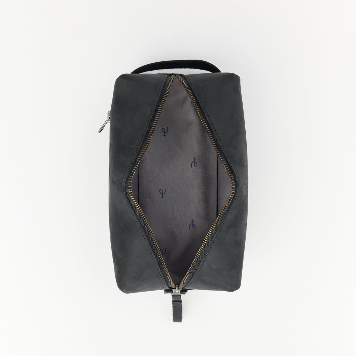 Black leather dopp kit with open zippered compartment and custom interior liner on a white background