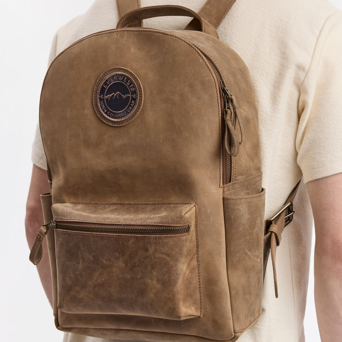 Brown leather backpack with the Everwest brand logo on a white background