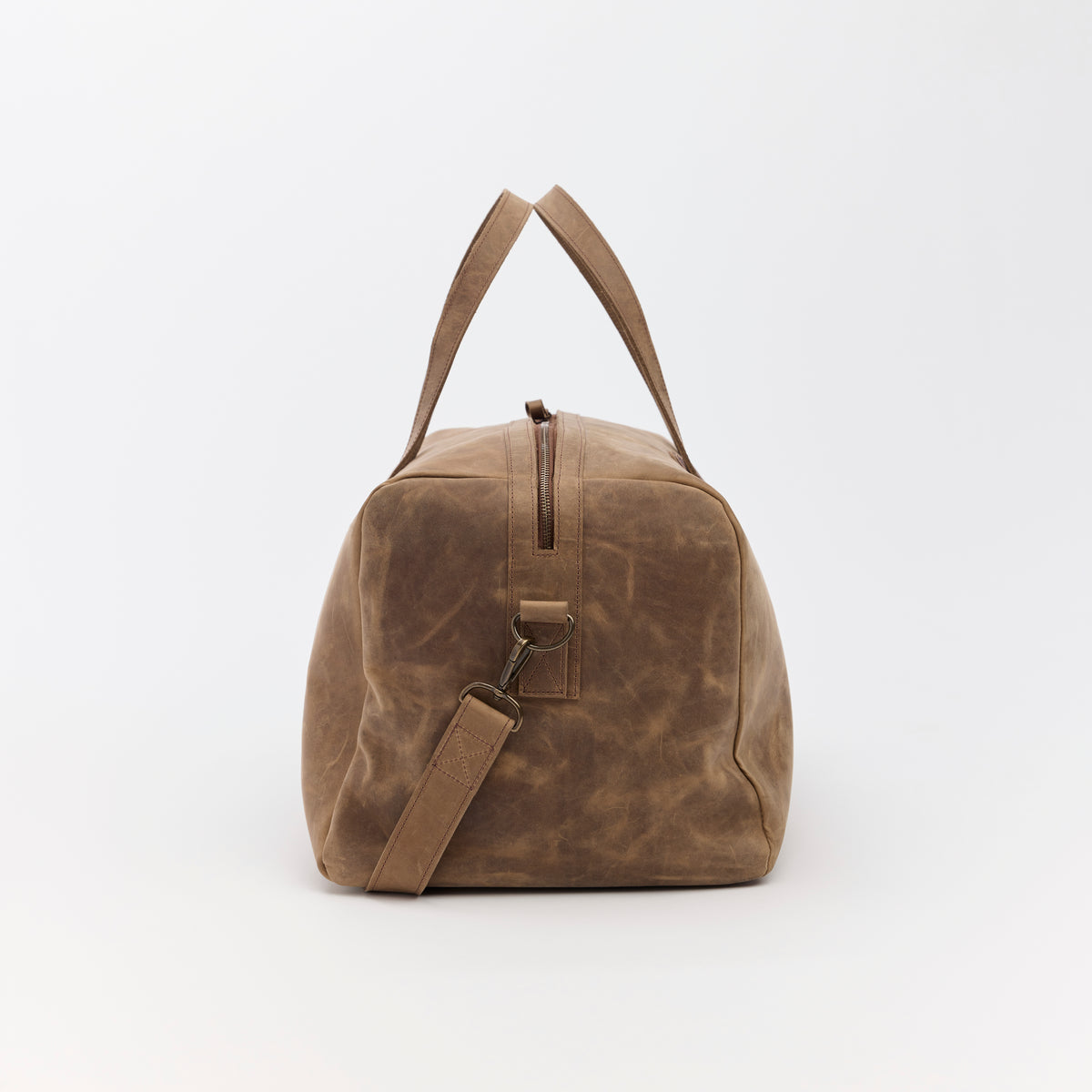Large brown leather duffel bag on a white background