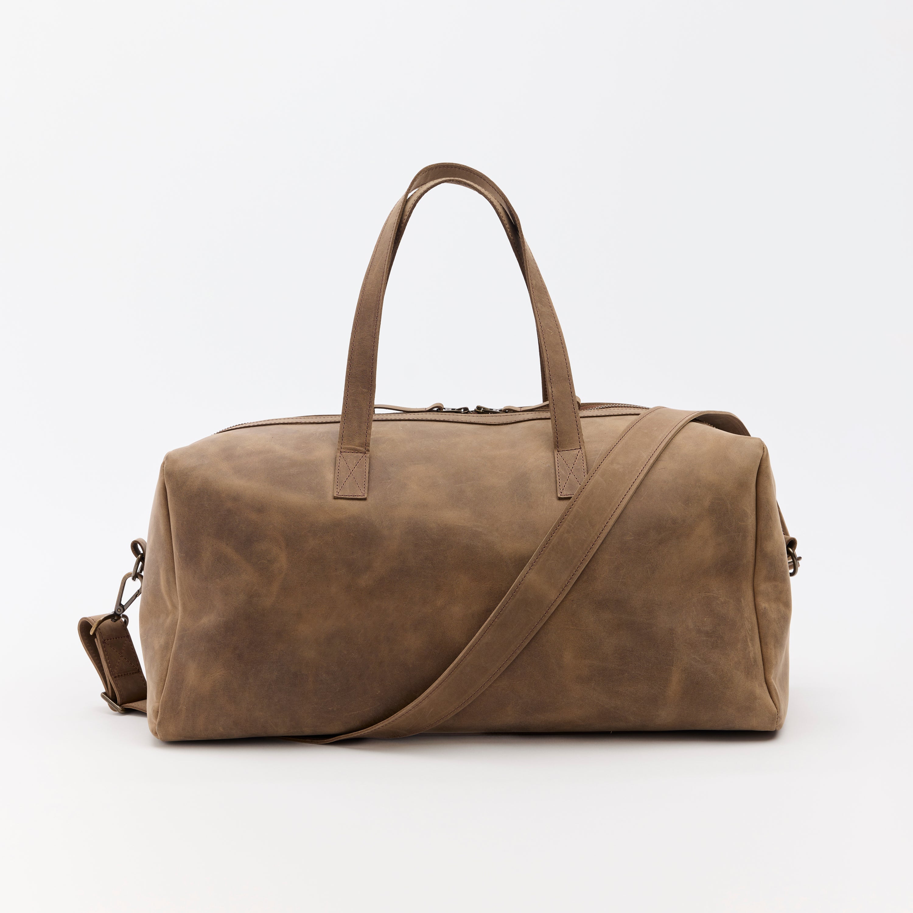Brown leather duffel bag on a white background