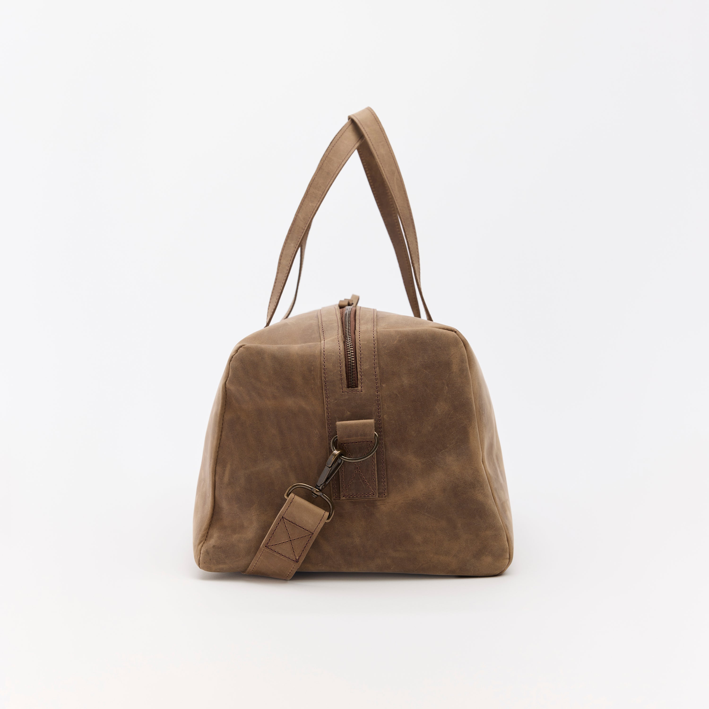 Brown leather duffel bag on a white background