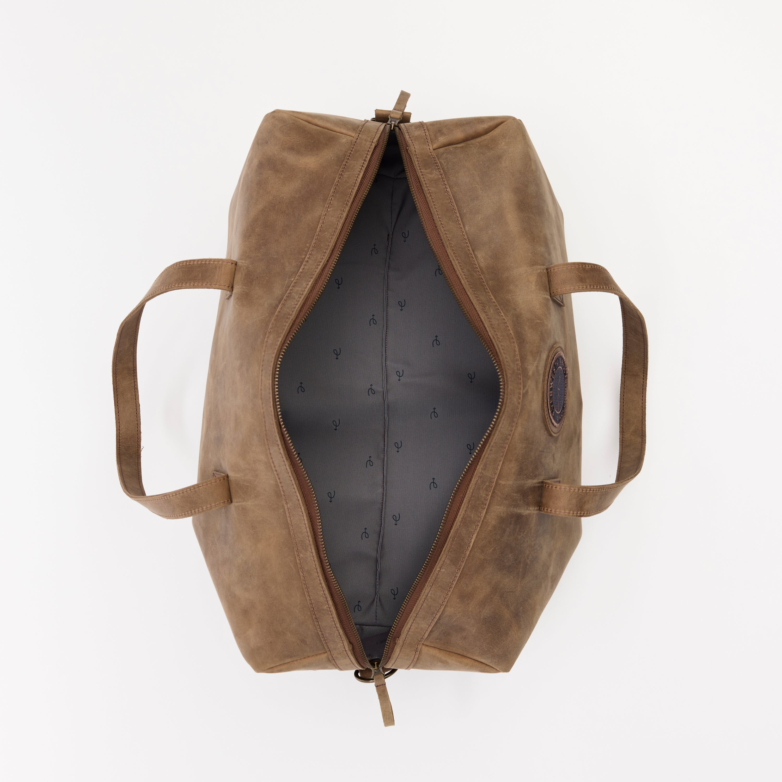 Brown leather duffel bag on a white background