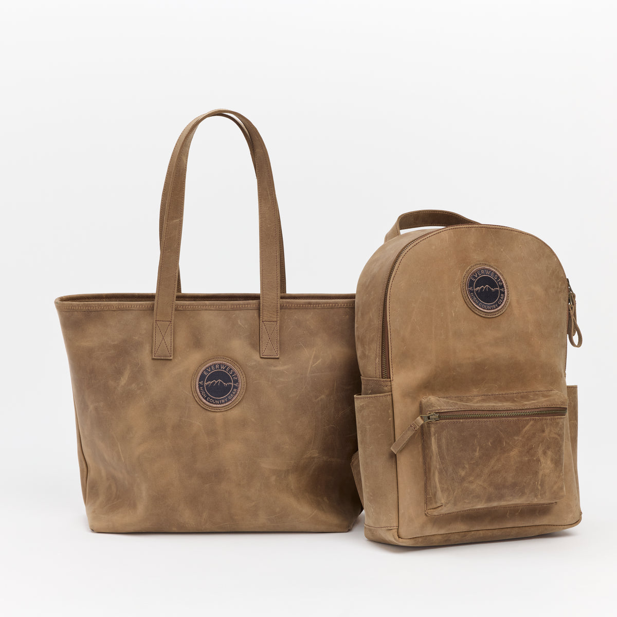 Brown leather tote bag and backpack set on a white background